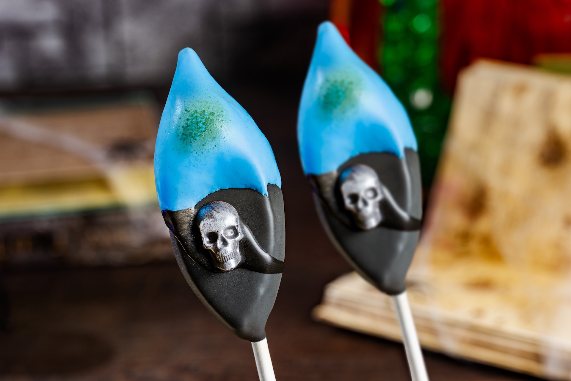 Hades Cake Pop: Mexican hot chocolate cake with popping candies dipped in chocolate with blue marshmallow 