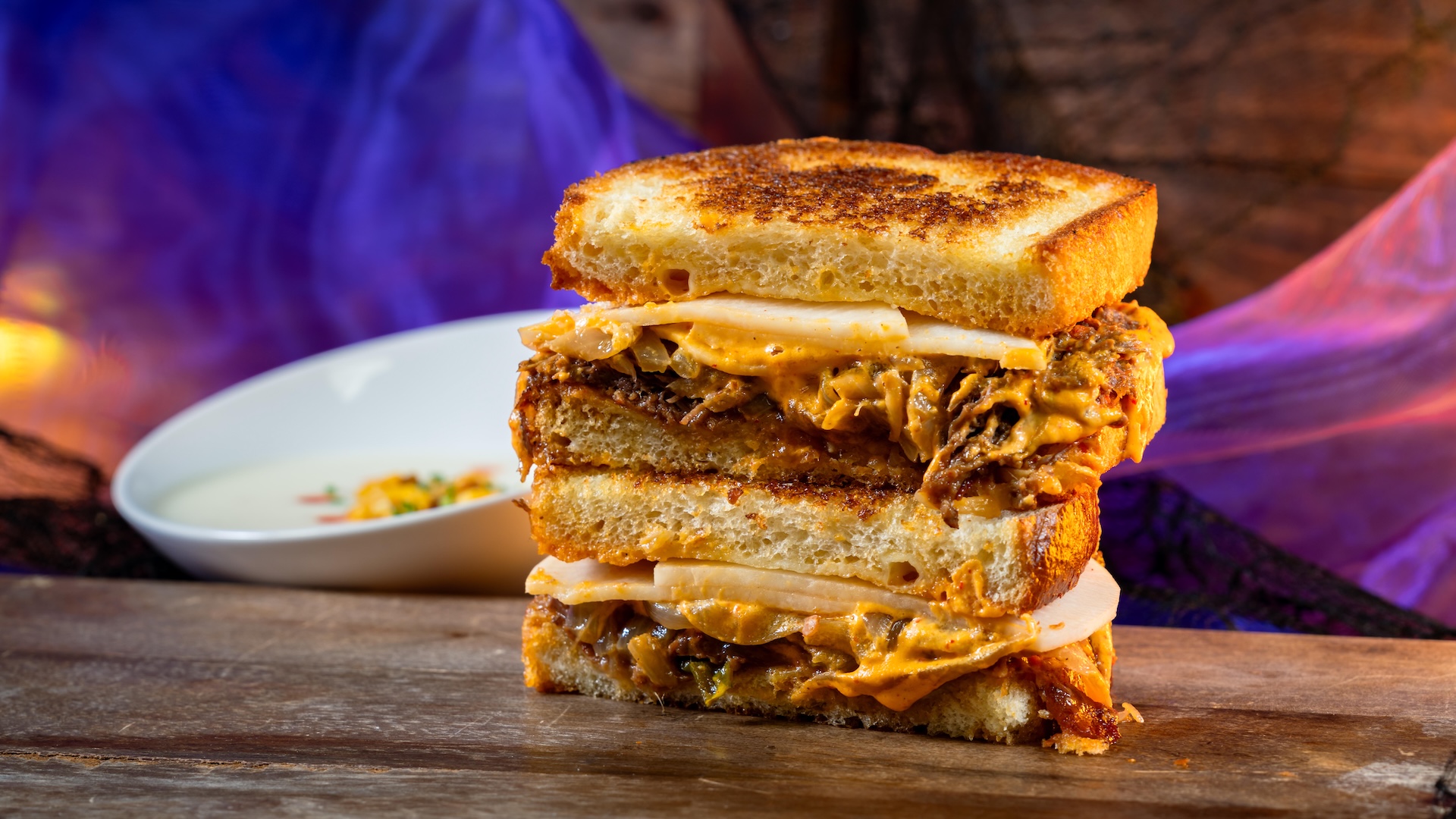 BooGogi Beef Toasted with Corn Cheese Soup: Marinated beef, grilled onion, mozzarella, pickled radish, and kimchi aïoli on sourdough served with corn cheese soup (Available Aug. 18 through Nov. 12)