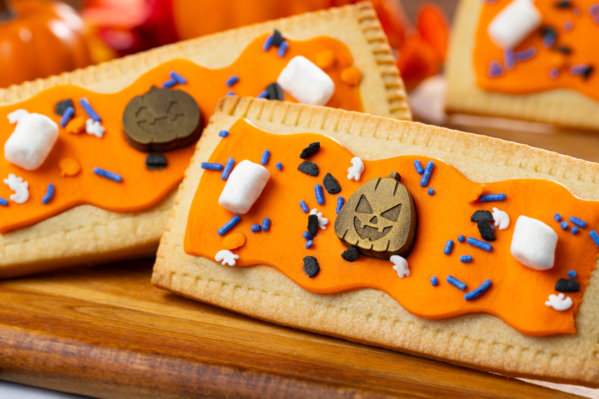 Pumpkin Lunch Box Tart: Pumpkin pie-filled pastry tart with marshmallow fondant, Halloween sprinkles, marshmallows, and chocolate jack-o'-lanterns 