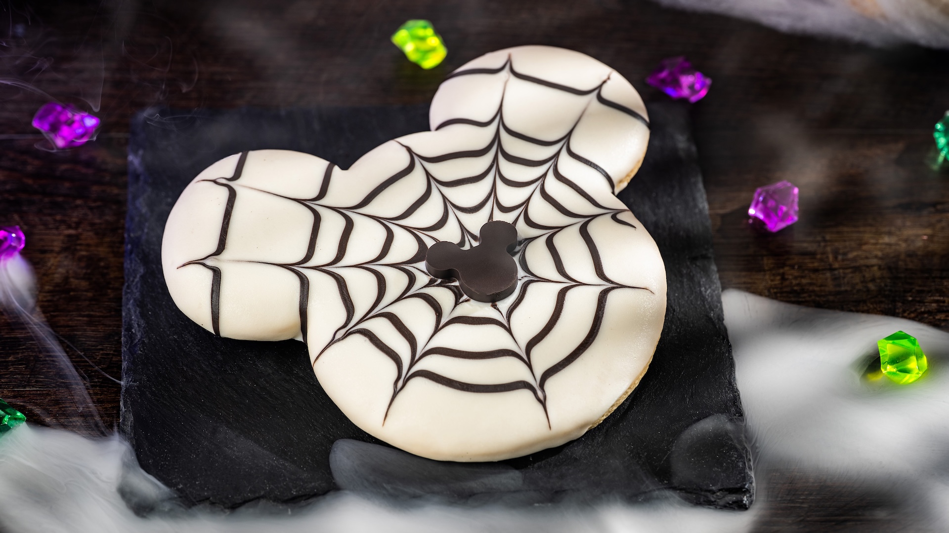 Large Mickey Spiderweb Cookie: Sugar cookie with colored chocolatey coating and chocolate Mickey piece 